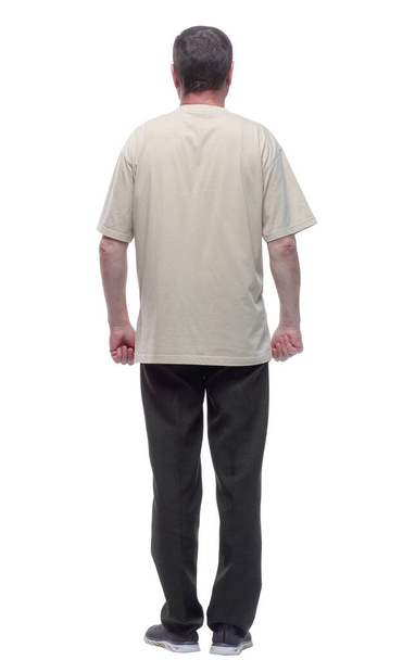 rear view. a man in a light t-shirt looking at a white screen. - Foto, Imagen