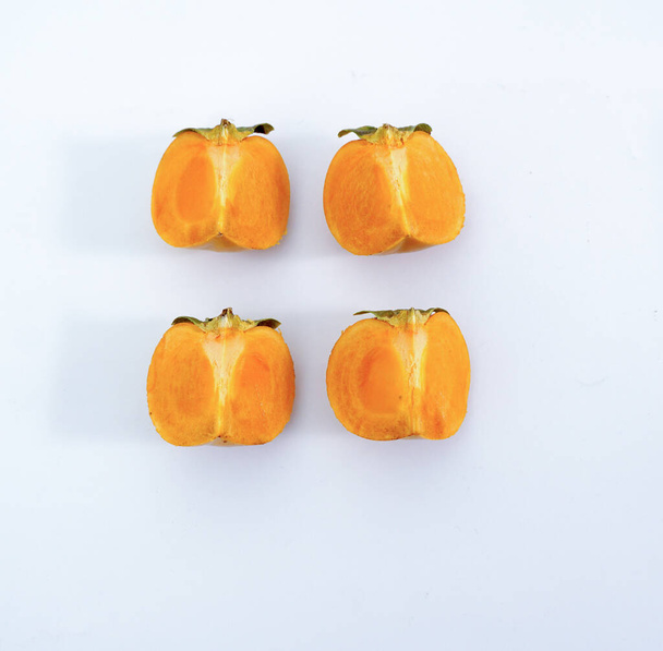 fresh ripe persimmons isolated on white background. - Фото, изображение