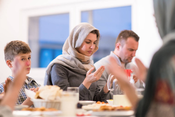 modern multiethnic muslim family praying before having iftar dinner - Foto, immagini