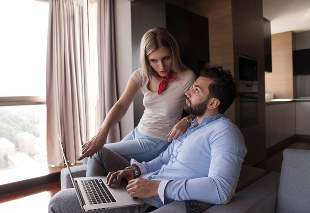 "couple relaxing at  home using laptop computers" - 写真・画像