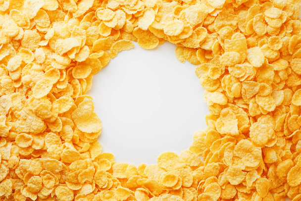 "Cornflakes dorati cornice piena con spazio vuoto copia rotonda al centro, come visto dall'alto
" - Foto, immagini