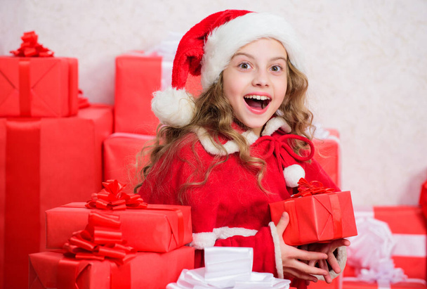 Santa bring her gift. Winter happiness concept. Explore christmas gifts. Unpacking christmas gift. New year holiday tradition. Kid excited about opening christmas present. Girl celebrate christmas. - Photo, image