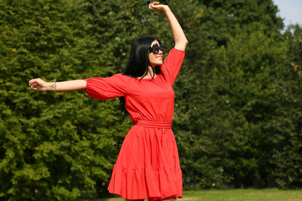 Happy young woman in red dress - Valokuva, kuva