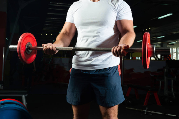 "Male athlete lifts the barbell" - Photo, image