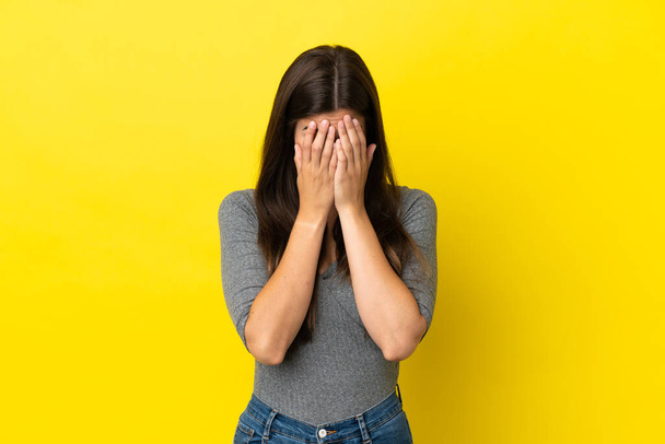 Young Brazilian woman isolated on yellow background with tired and sick expression - Foto, immagini