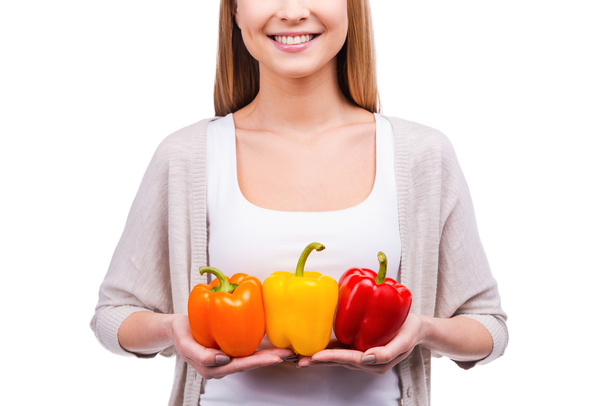Young woman holding peppers - Foto, Imagen