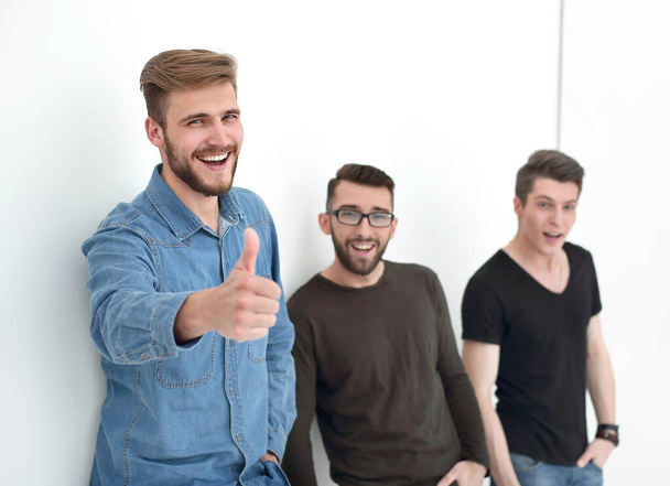 casual men next to the wall showing thumbs up - Photo, Image
