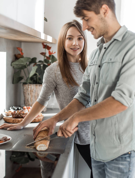 "happy young couple with food in their new kitchen - 写真・画像