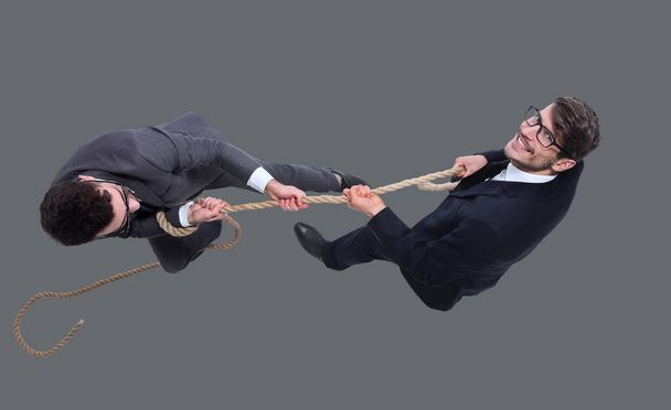 two businessmen pulling a long rope. - Photo, Image