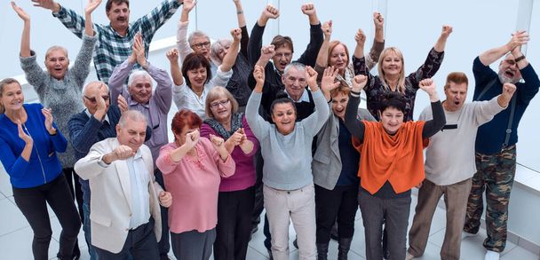 group of mature friends raised their hands up and celebrate  - Foto, Imagen