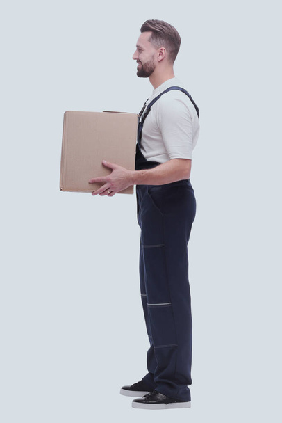 side view. smiling man passing a cardboard box - Photo, Image