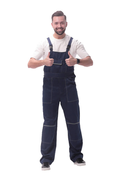 "in full growth. friendly man in overalls showing thumbs up" - Foto, immagini