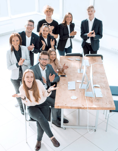 "top view. a group of happy employees in the workplace." - Foto, Bild