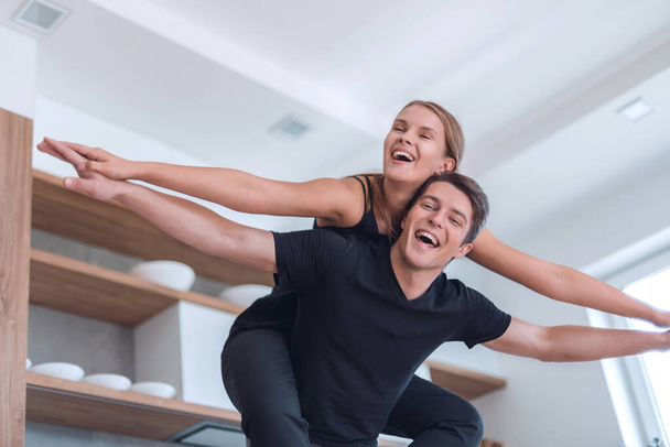 young married couple having fun in their new kitchen - Foto, Bild