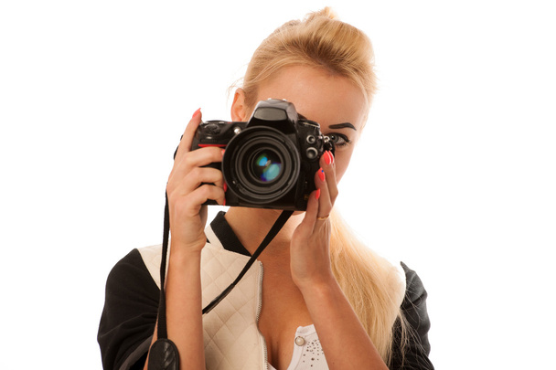Woman holding a camera taking photos isolated over white backgro - Foto, afbeelding