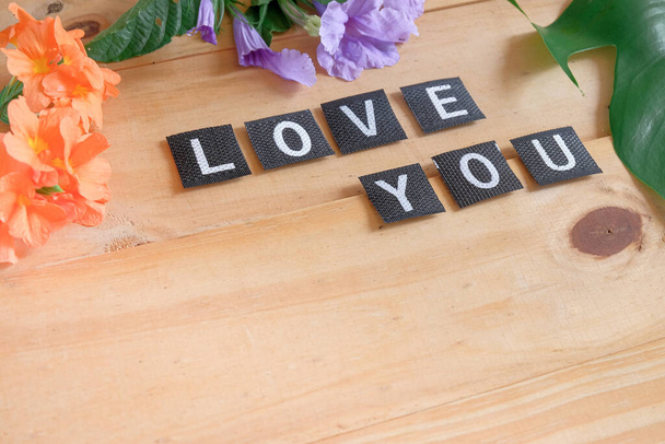 Love you tag with flower on wood table. - Photo, Image