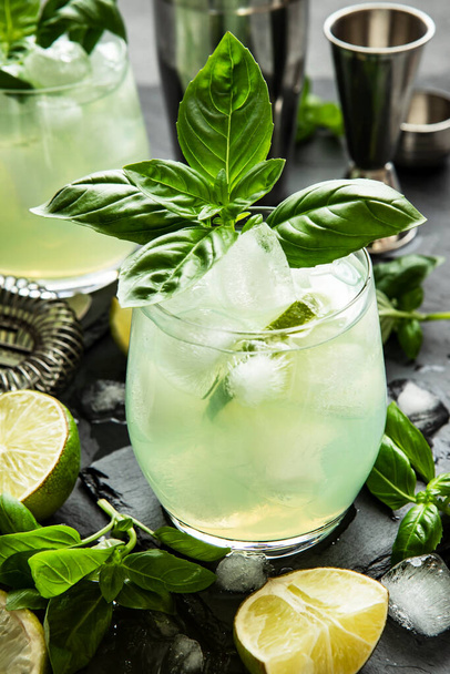 Refreshing drink with basil   leaves on dark concrete  background, selective focus - Fotó, kép
