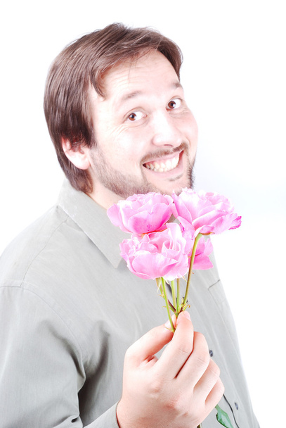 Cute man offering pink roses - Фото, изображение