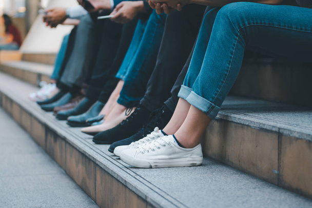 Group of group diverse people sitting together at the stair , close up at legs - Fotoğraf, Görsel