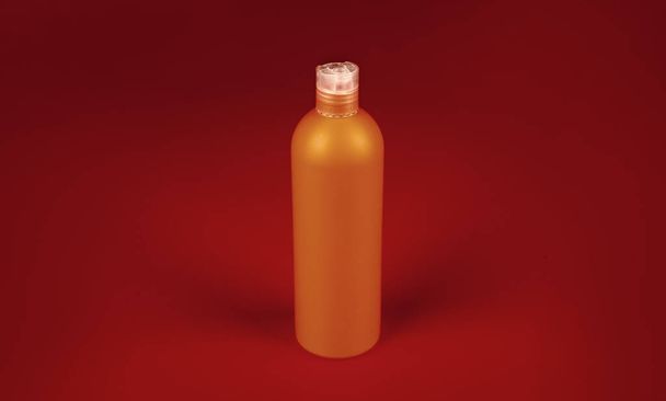 shampoo bottle on orange background, beauty product. - Photo, image