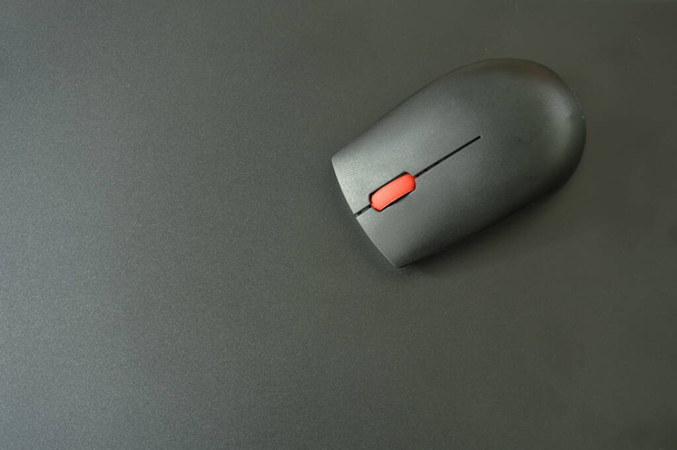 gray computer mouse on black laptop background  - Photo, Image