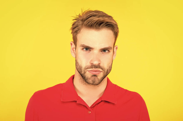 serious guy with bristle on yellow background, casual. - 写真・画像