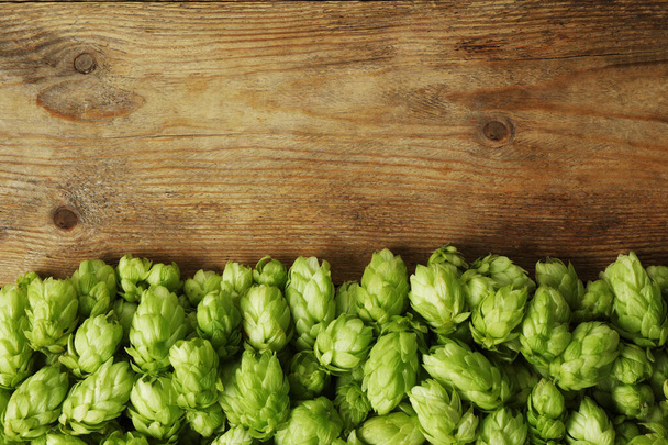 Fresh green hops on wooden table, top view. Space for text - Foto, immagini