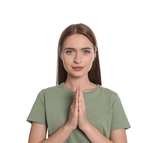 Woman with clasped hands praying on white background - Foto, immagini