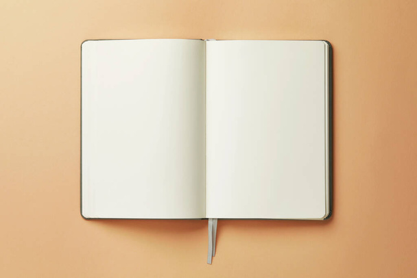 Open notebook on beige background, top view - Фото, зображення