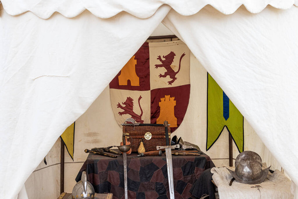 closeup in horizontal view of interior of a 17th century Spanish soldier tent with weapons and clothing that were used at the time.historical recreations - Photo, Image