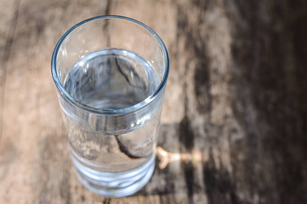 Glass of water on wooden surface outdoors, closeup. Space for text - Foto, Imagem