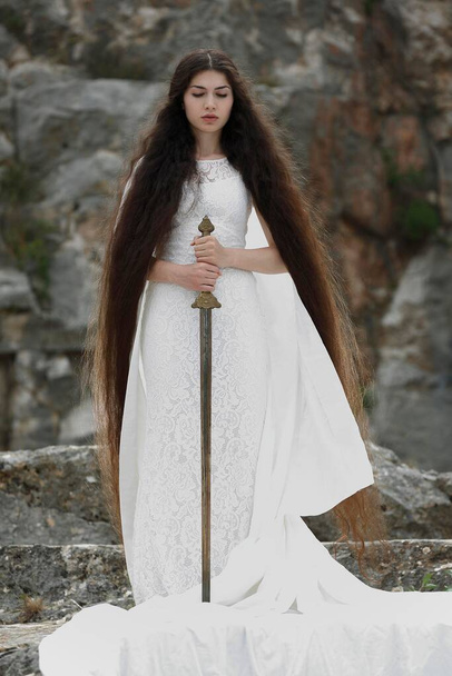 Reminiscence to Joan of Arc, Jeanne d'Arc, young woman in a white dress with a sword - Photo, image