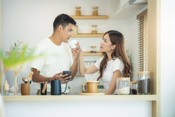 Couple, 2 people or lover to made, drink coffee together in kitchen, home in morning. Include coffee cup or mug, blind and light from window. Concept for lifestyle, love, happy, family, relationship. - Photo, image