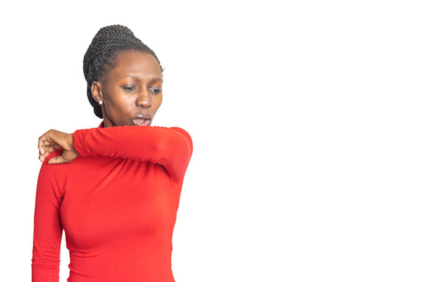 Young african woman coughing and covering her mouth. Isolated white background - Foto, imagen