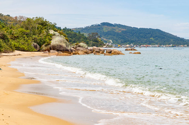 Пляж с песком, камнями и лесом в Governador Celso Ramos, Santa Catarina, Brazil - Фото, изображение