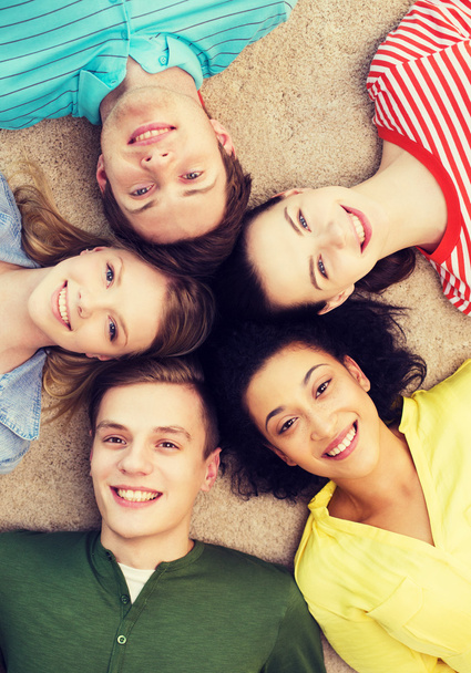 group of smiling people lying down on floor - Photo, image