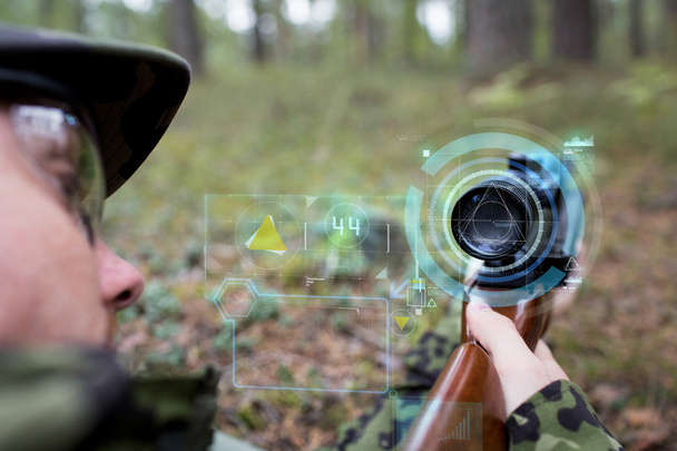 close up of soldier or sniper with gun in forest - 写真・画像