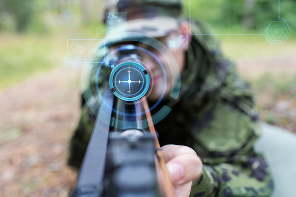 close up of soldier or sniper with gun in forest - Fotoğraf, Görsel