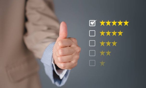 closeup businesswoman thumb up with checked box on 5 stars rating, satisfactory survey concept - Photo, Image