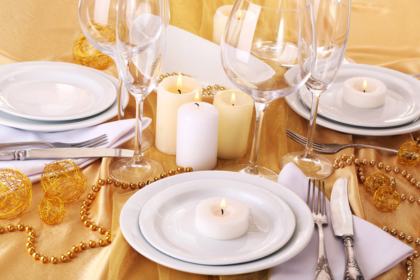 Beautiful holiday table setting in white and gold color  - 写真・画像