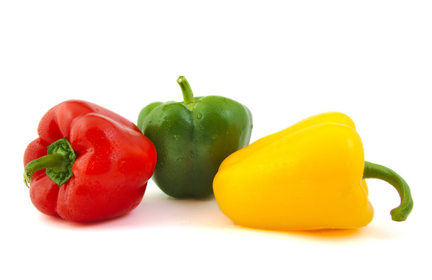 Nahaufnahme grüner, roter und gelber frischer Paprika auf weißem Hintergrund. - Foto, Bild