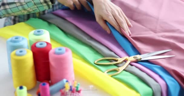 Seamstress chooses multi-colored fabric for tailoring. Atelier services concept - Footage, Video
