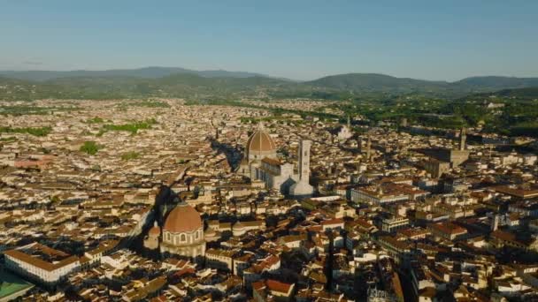 Aerial slide and pan footage of Florence Cathedral and surrounding popular landmarks in tourist attractive historic city. Florence, Italy. - Footage, Video