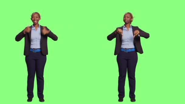 Office worker on two sides showing thumbs up and down, mixed emotions on full body greenscreen backdrop. Doing like and dislike gesture, approval or disapproval on isolated background. - Footage, Video