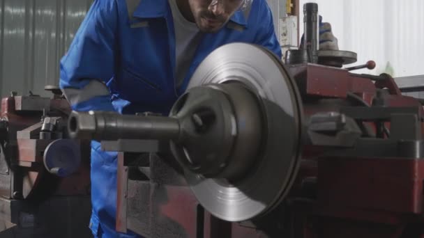 Young man sanding or iron at industrial factory, mechanic working job while polish metal, male having skill built steel with tool, engineer and equipment, labor and steelworks, industry concept. - Video, Çekim