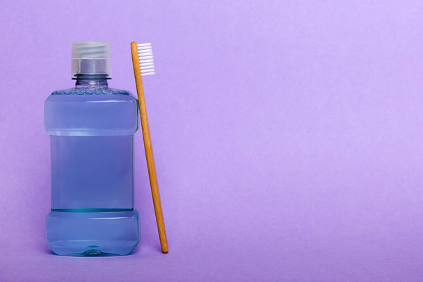 Mouthwash and other oral hygiene products on colored table top view with copy space. Flat lay. Dental hygiene. Oral care products and space for text on light background. concept. - Valokuva, kuva
