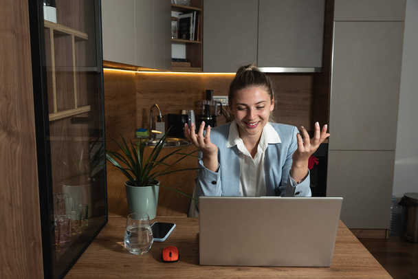 Young freelancer woman sitting at home with laptop having online job interview while she wearing formal wear talking to employee manager human resource people on video call web conference on computer. - Фото, зображення