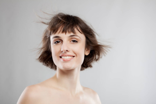 studio portrait of a beautiful brunette girl with short hair in the air - Fotoğraf, Görsel