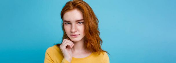 Headshot Portrait of happy ginger red hair girl with freckles smiling looking at camera. Pastel blue background. Copy Space. - Valokuva, kuva