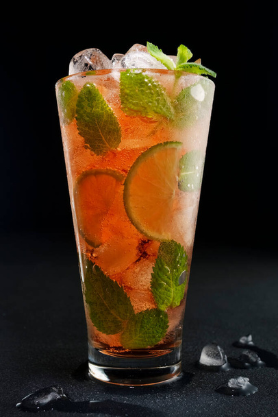 Alcoholic refreshing red cocktail with mint, lime and ice - Photo, Image